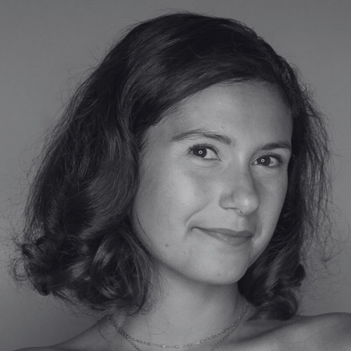 Black and white portrait of a woman with shoulder-length hair against a plain background